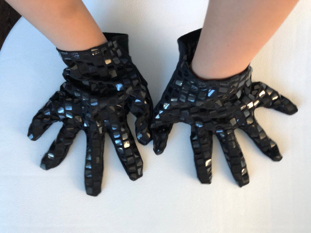 the finished sequined gloves on the child
