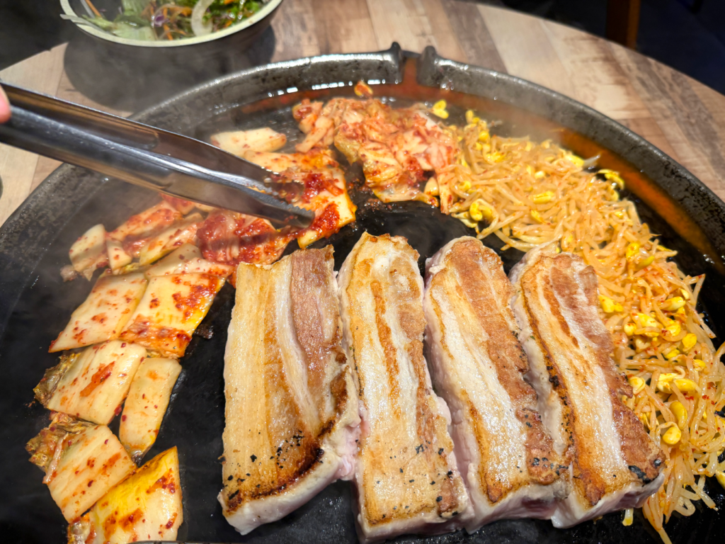 Pork belly grilling at Pigya, a Korean BBQ in Koreatown LA