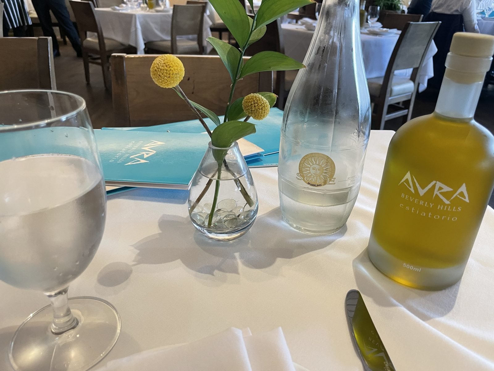 Table setting with Avra olive oil at Avra Beverly Hills
