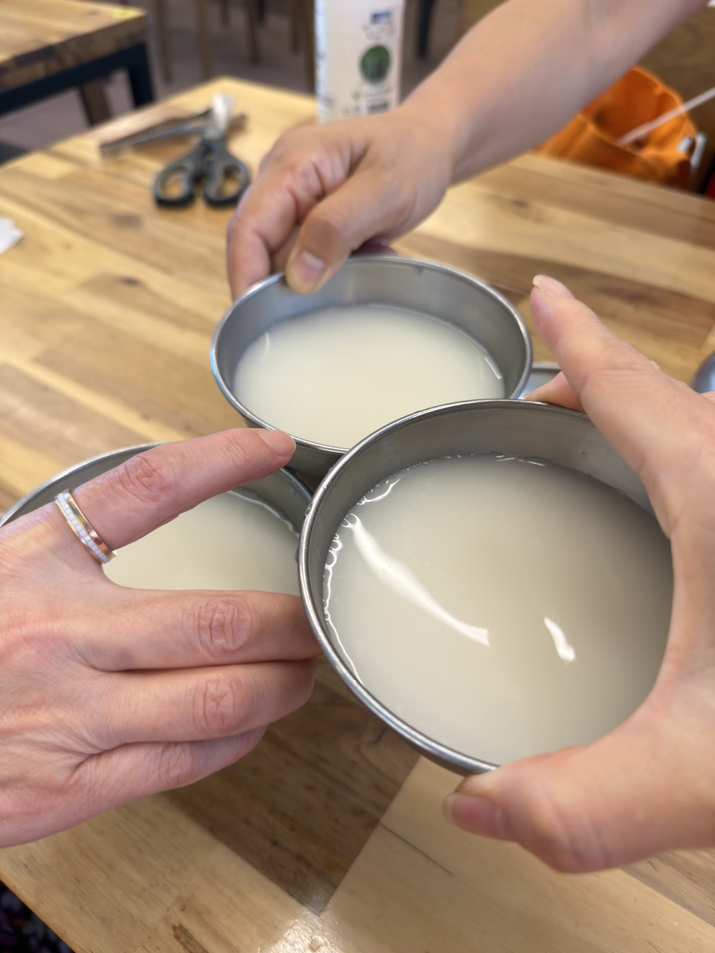 Makgeolli being poured into traditional metal bowls at a noodle shop in Damyang