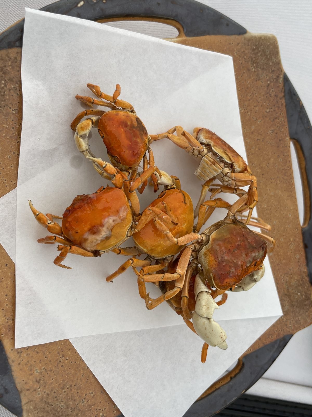 Crisp fried soft-shell crabs served on paper at Matsumoto sushi