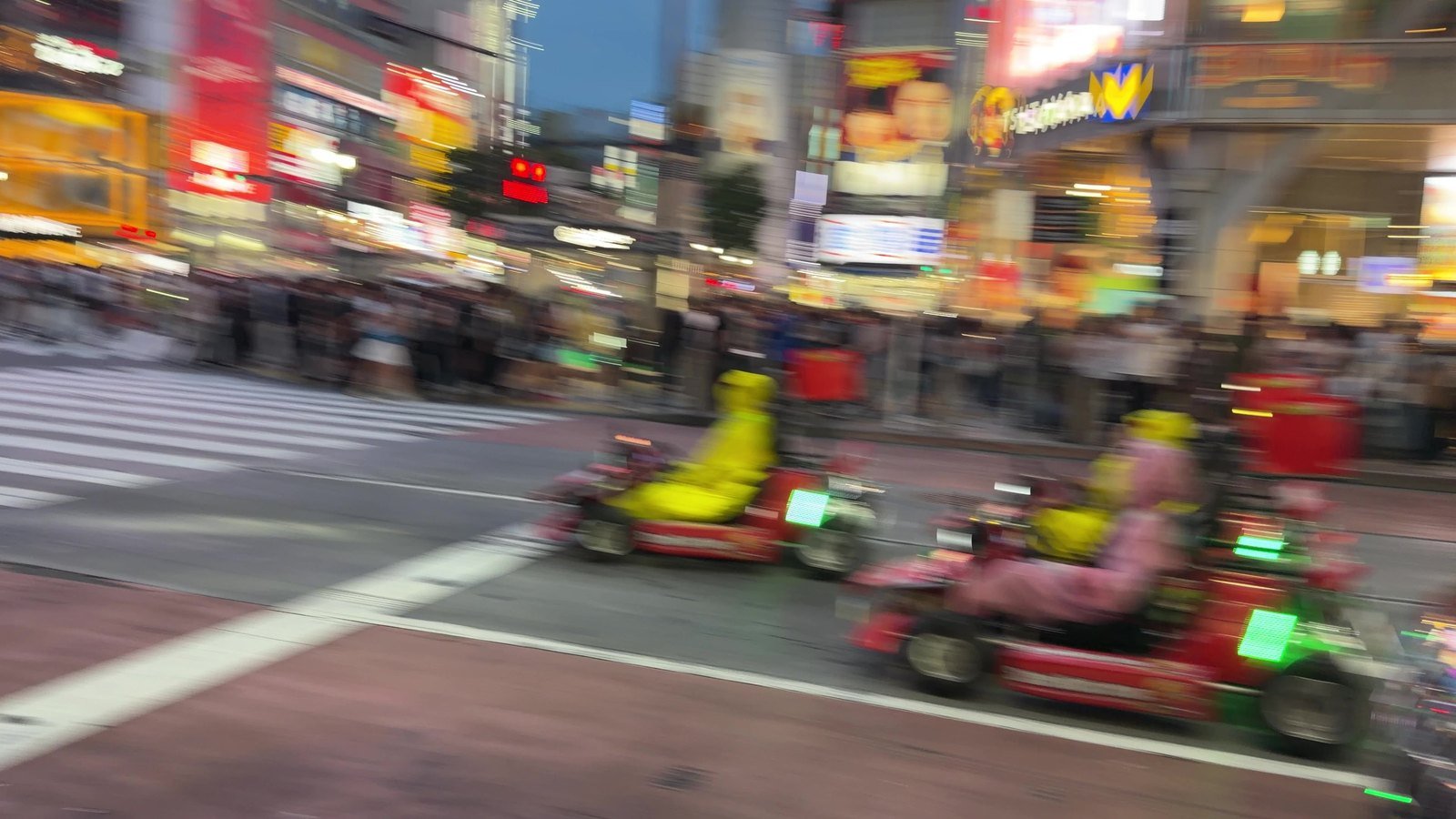 Go-karts driving through Shibuya Crossing at night