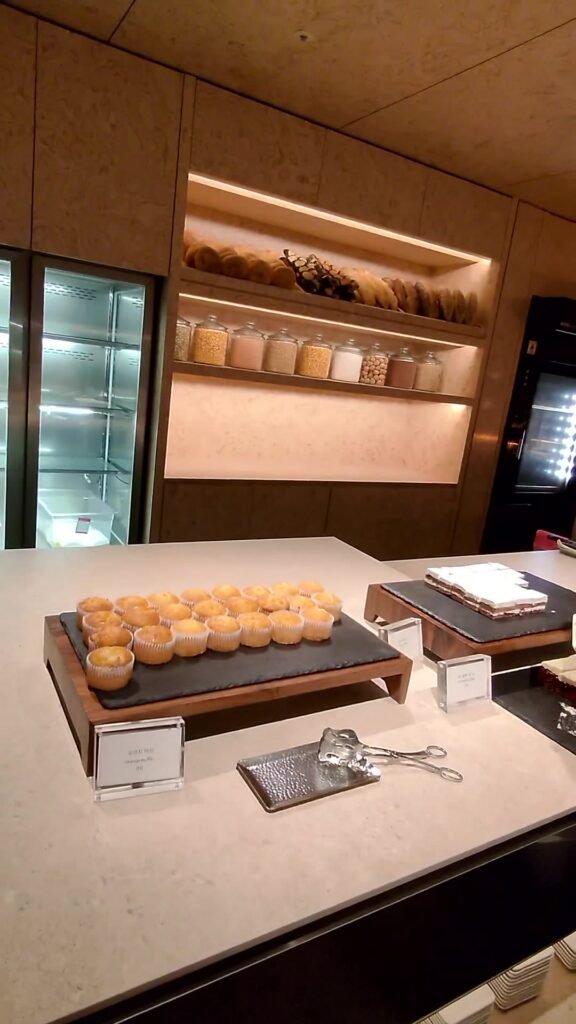Bread and dessert counter with pastries and grain jars at the Korean Air Prestige lounge in Incheon
