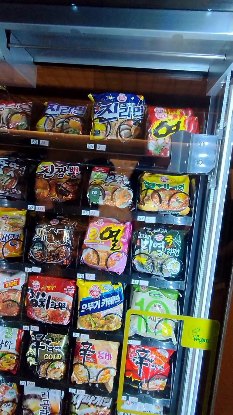 Rows of Korean instant ramen packets in a lit glass cabinet at the Korean Air lounge in Incheon Airport Terminal 2