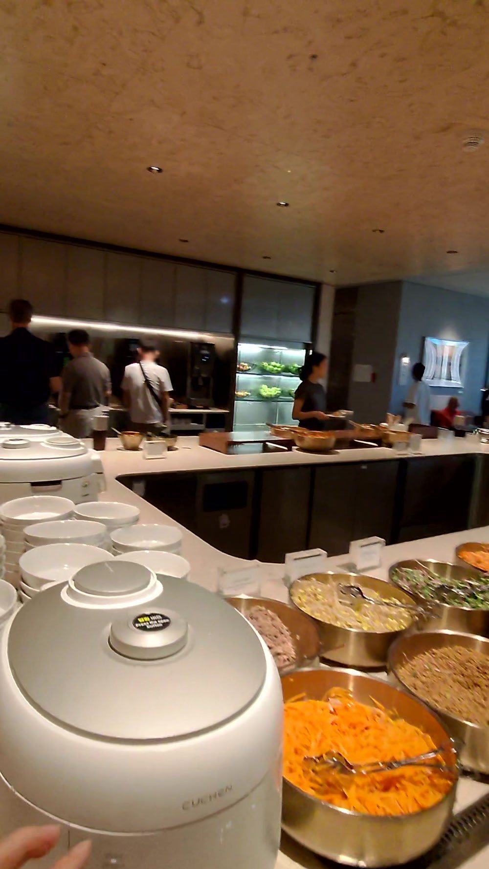 Rice cookers and namul bowls at the build-your-own bibimbap station in the Korean Air lounge at Incheon