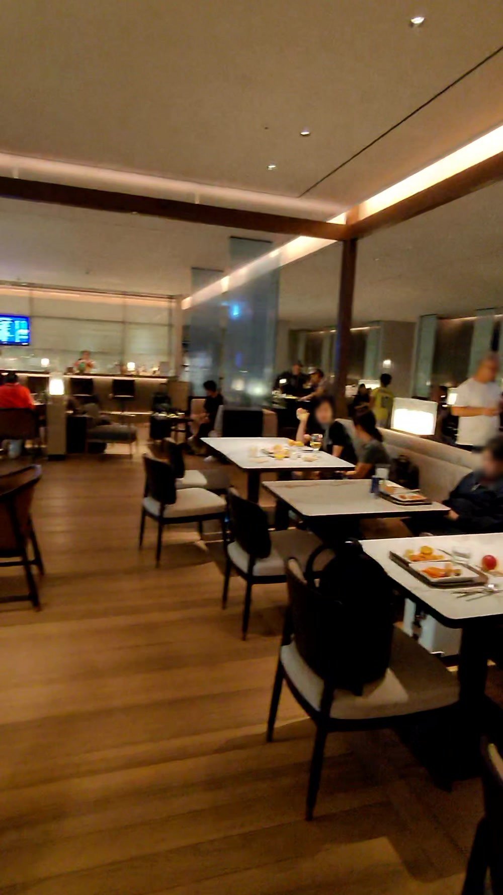 Marble tables and banquette seating in the dining area of a Korean Air lounge at Incheon Terminal 2