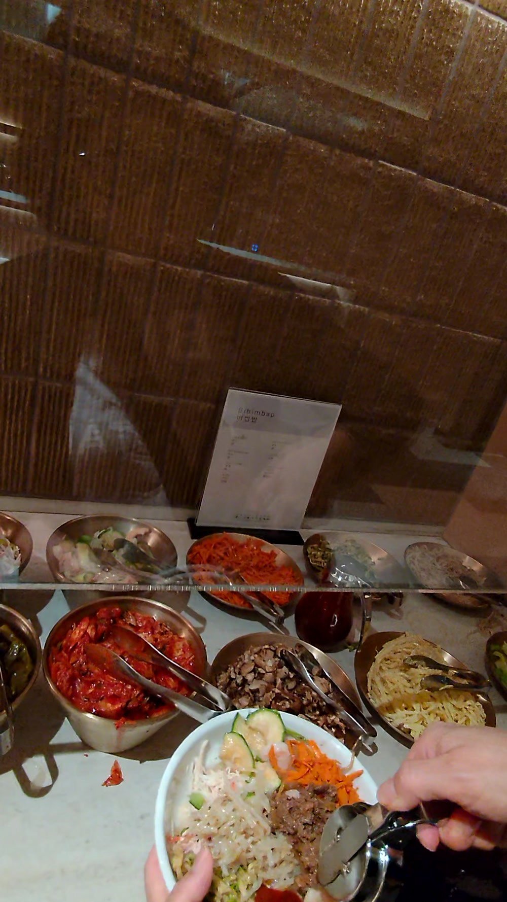 A finished bibimbap bowl assembled from the buffet at the Korean Air lounge at LAX
