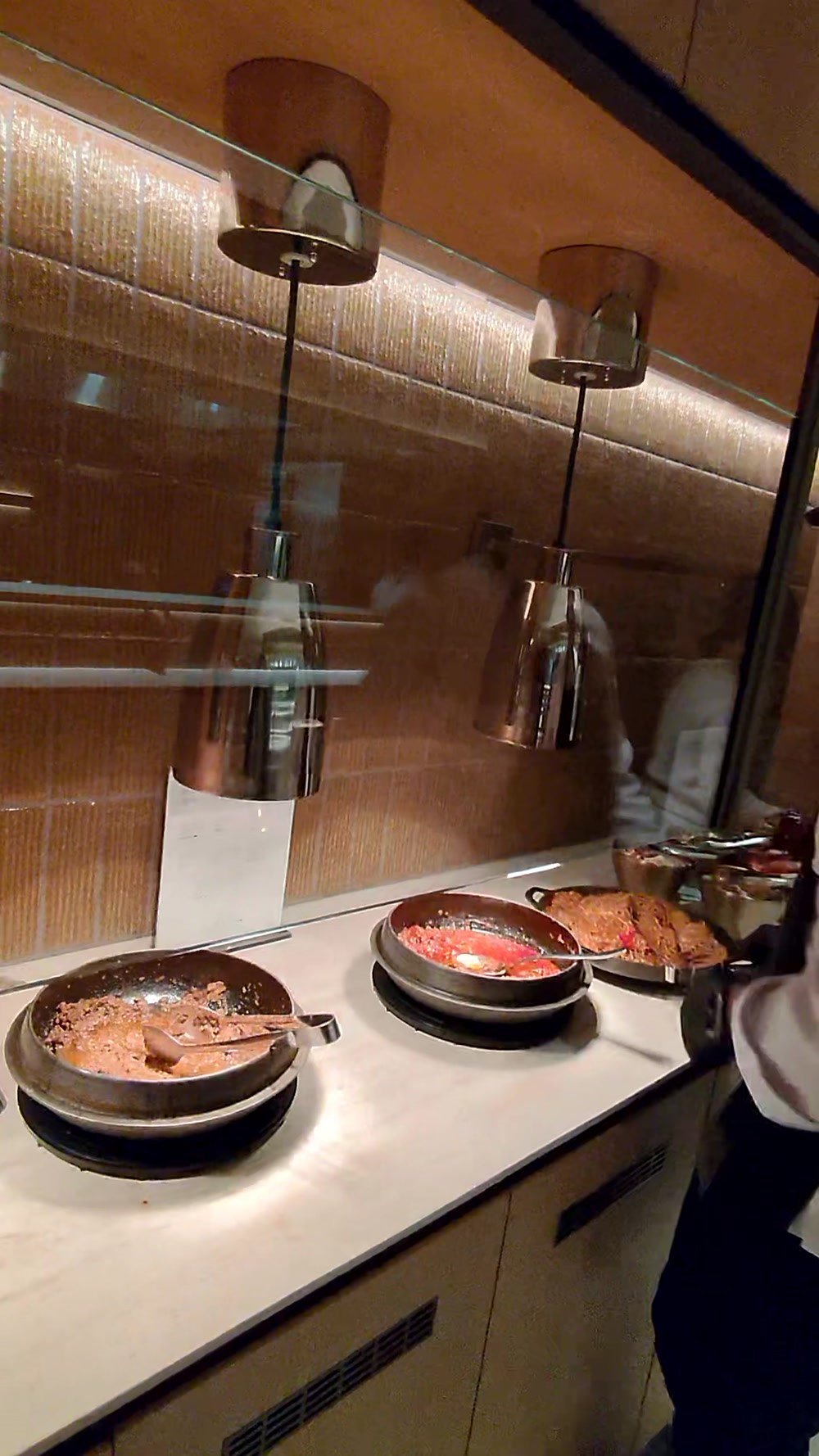 Hot pans of Korean food at the live cooking station in the Korean Air lounge at LAX