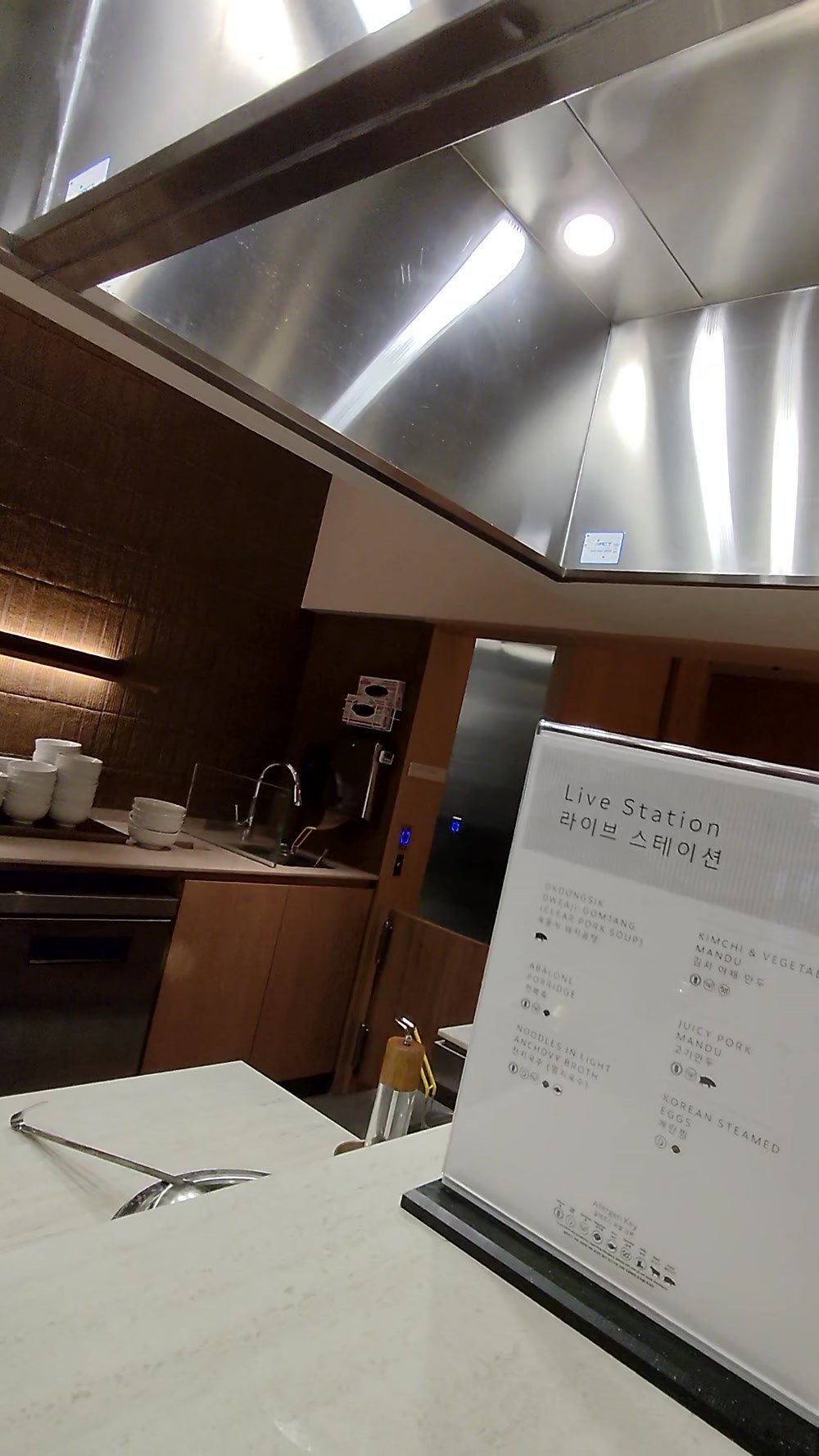 The Live Station sign at the open kitchen counter in the Korean Air lounge at LAX
