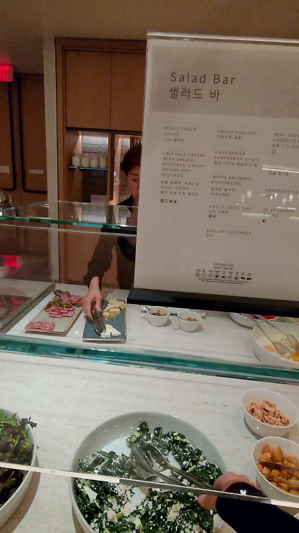 The Salad Bar sign and fresh salad bowls at the Korean Air lounge at LAX