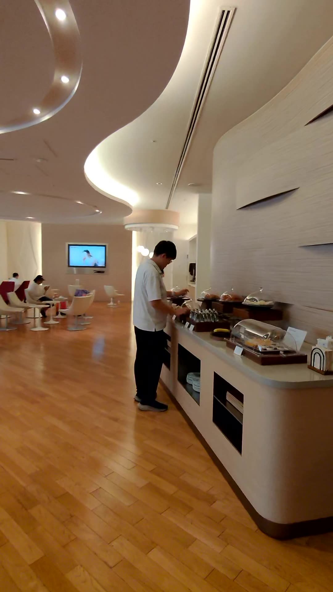 The main room of the Korean Air lounge at Narita Airport Terminal 1, with a buffet counter and wood floors
