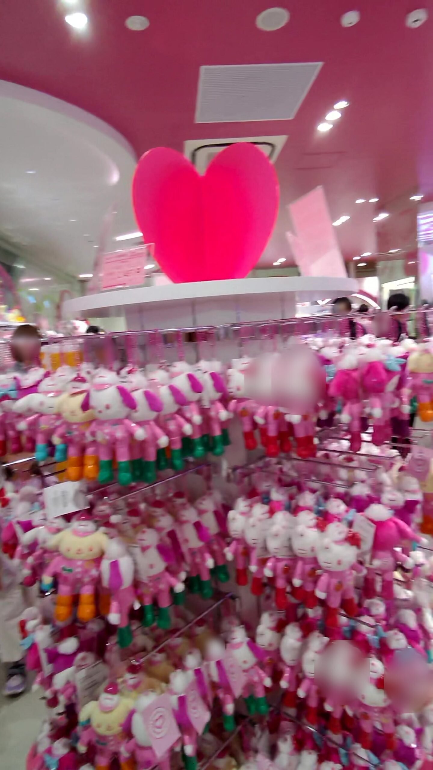 A wall of pink plush toys inside a character goods store in Harajuku
