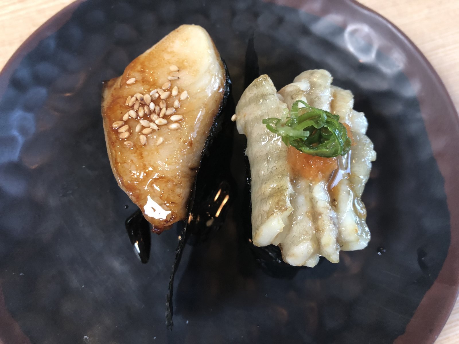 Beverly Hills Sasabune glazed fish nigiri with sesame and scored squid nigiri