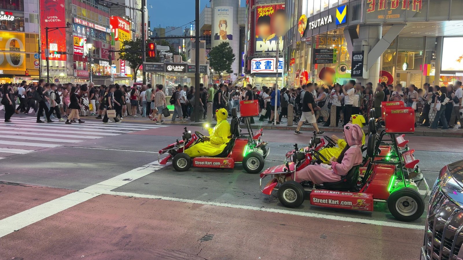 Street Kart go-karts with costumed drivers stopped at Shibuya Crossing