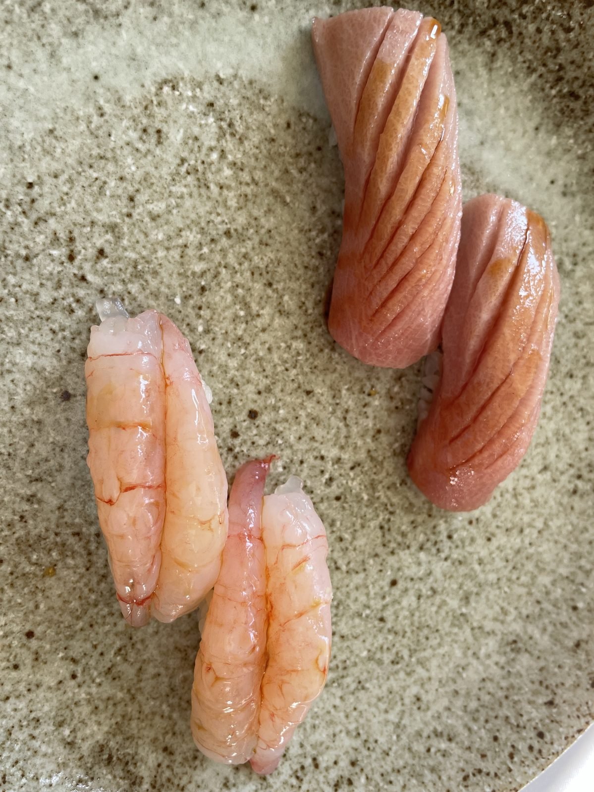 Sweet shrimp and yellowtail nigiri on a sand-glazed plate at Matsumoto sushi