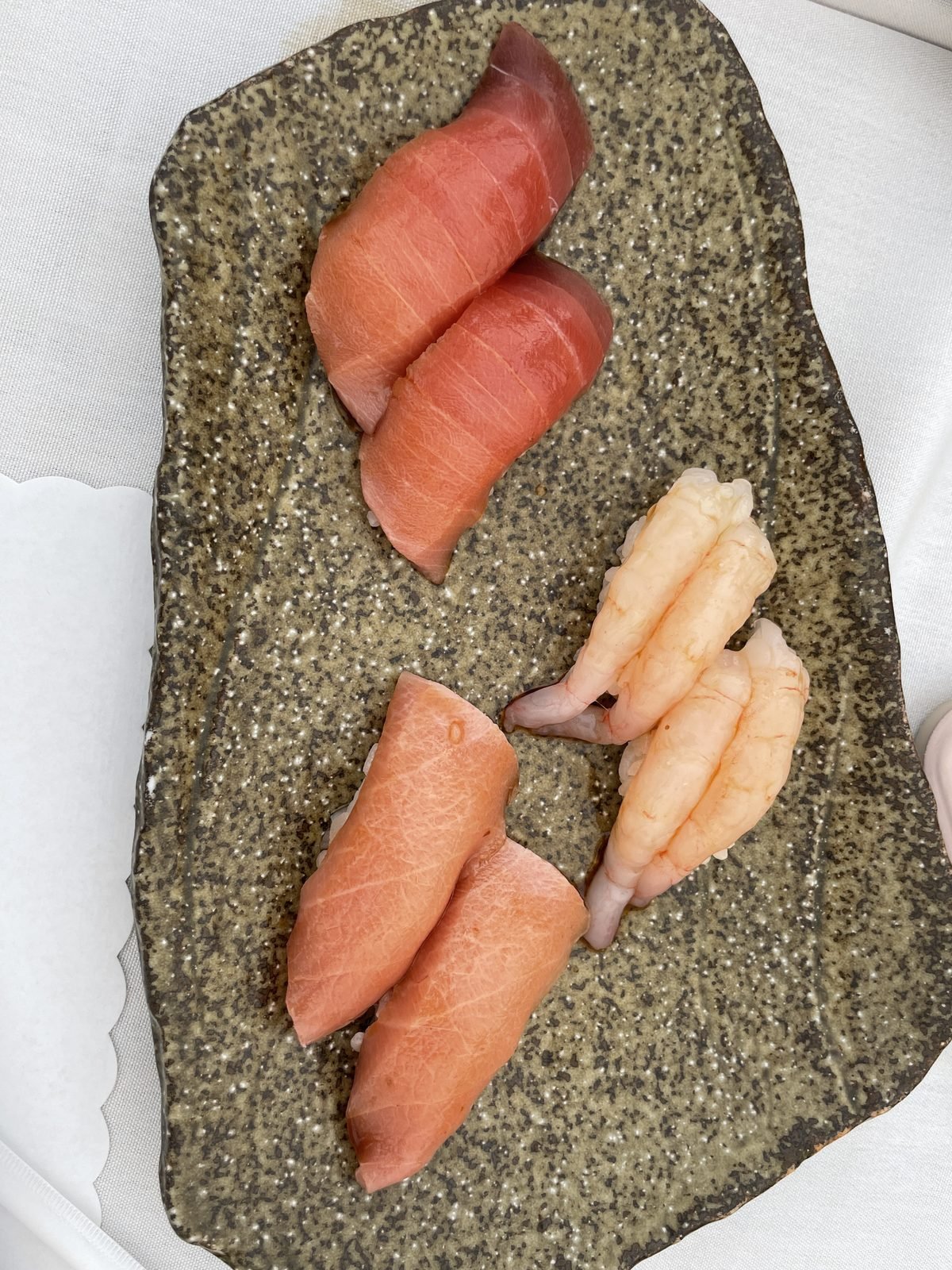Toro and sweet shrimp nigiri laid on a stone plate at Matsumoto sushi