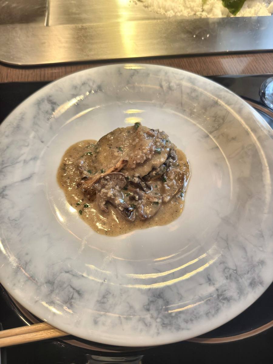 Tokyo Ginza Ukai-tei grilled abalone in sauce on a marble plate