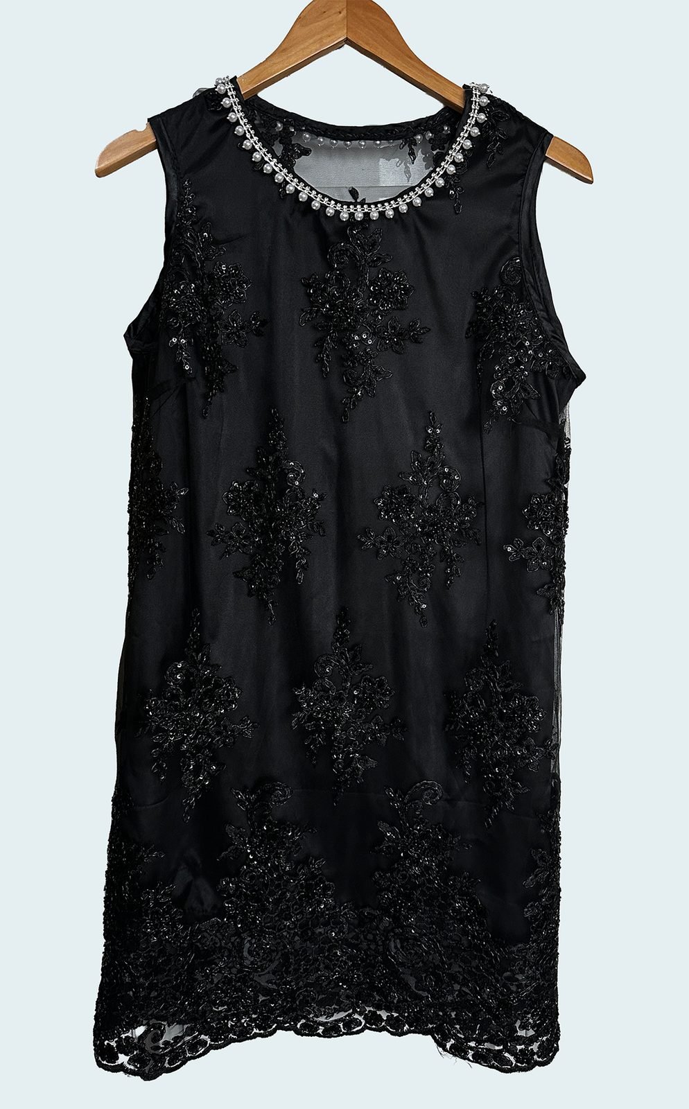 Handmade black dress with pearls hand-stitched along the neckline