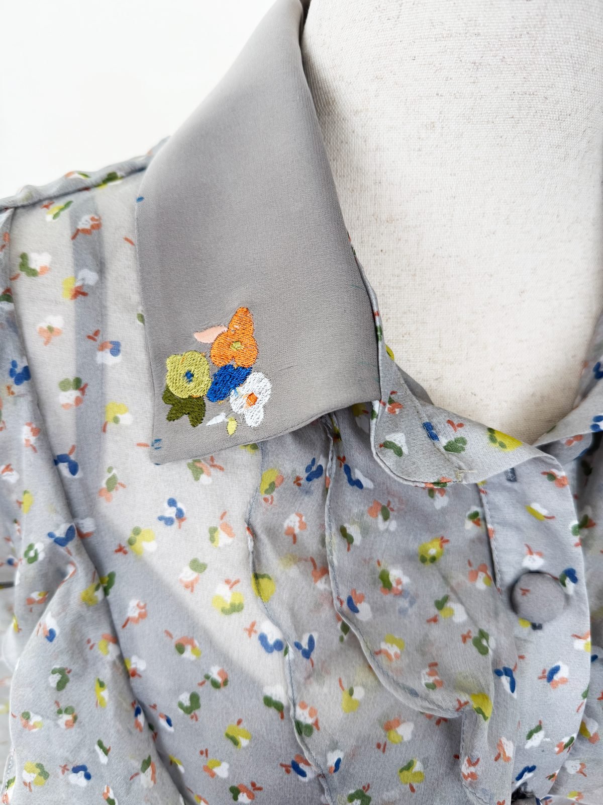 Embroidered collar detail with the fabric flower enlarged and stitched by machine