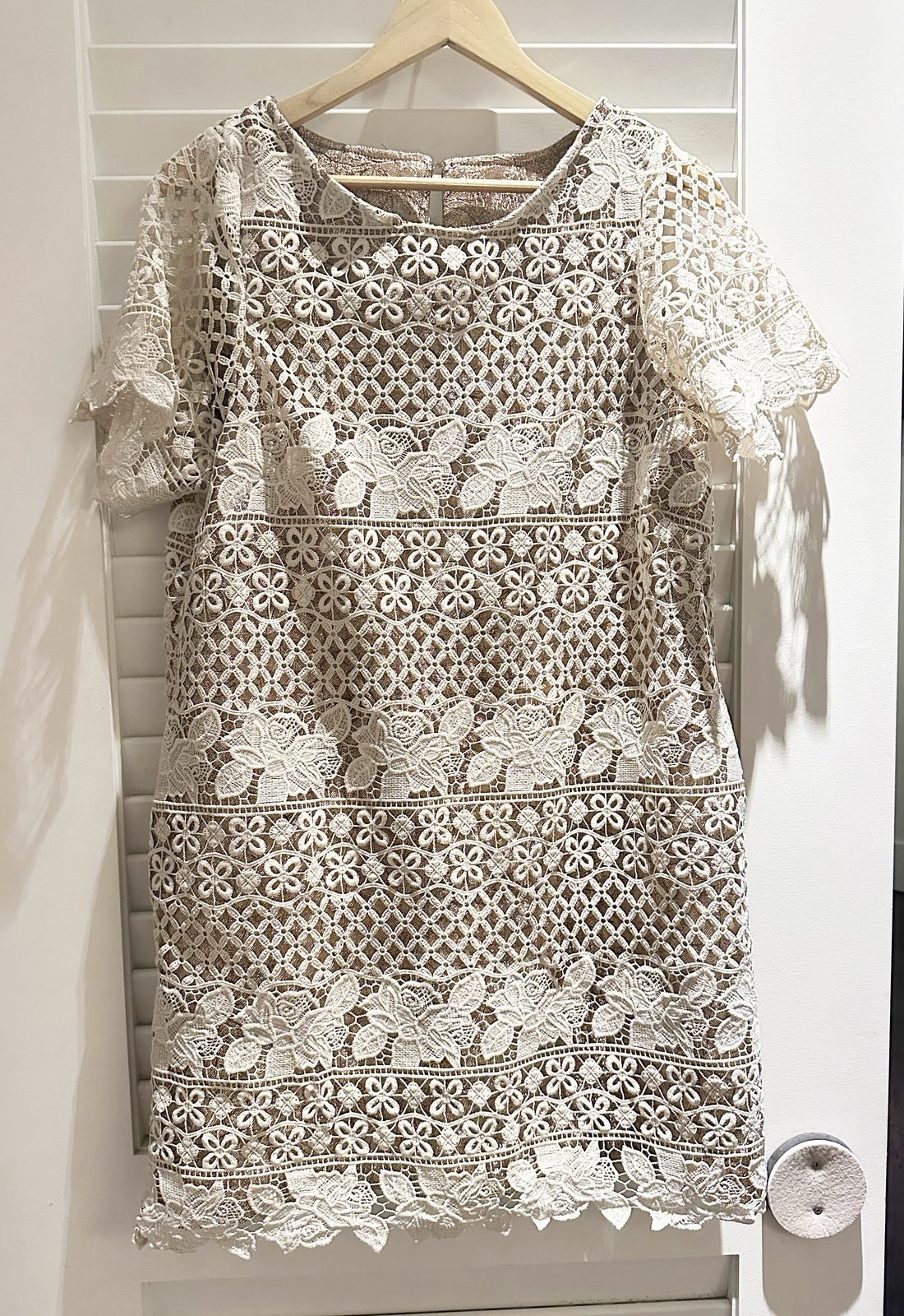 Handmade ivory guipure lace dress on a hanger