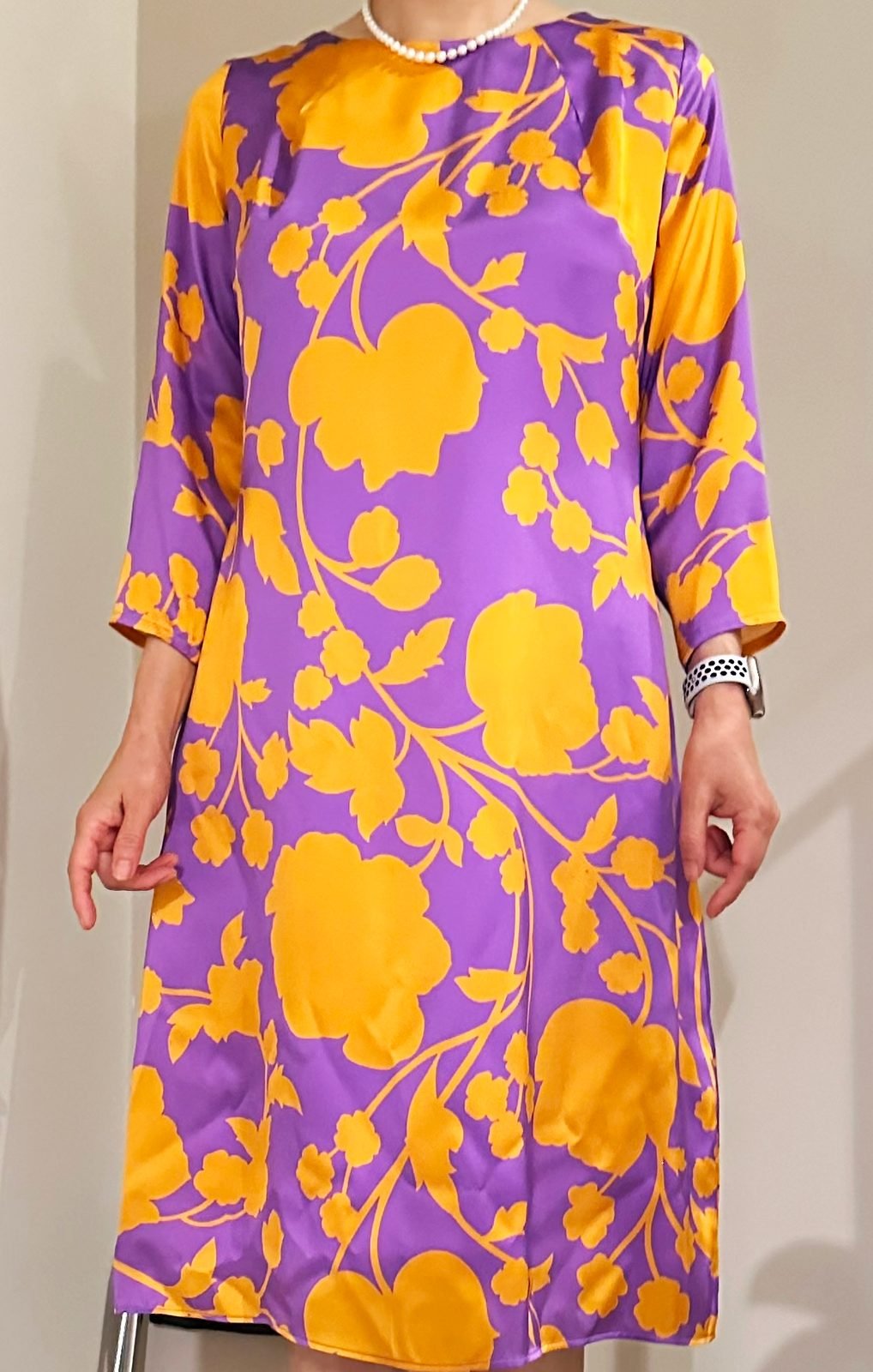 The orchid and orange floral dress worn, showing how the print reads on the body