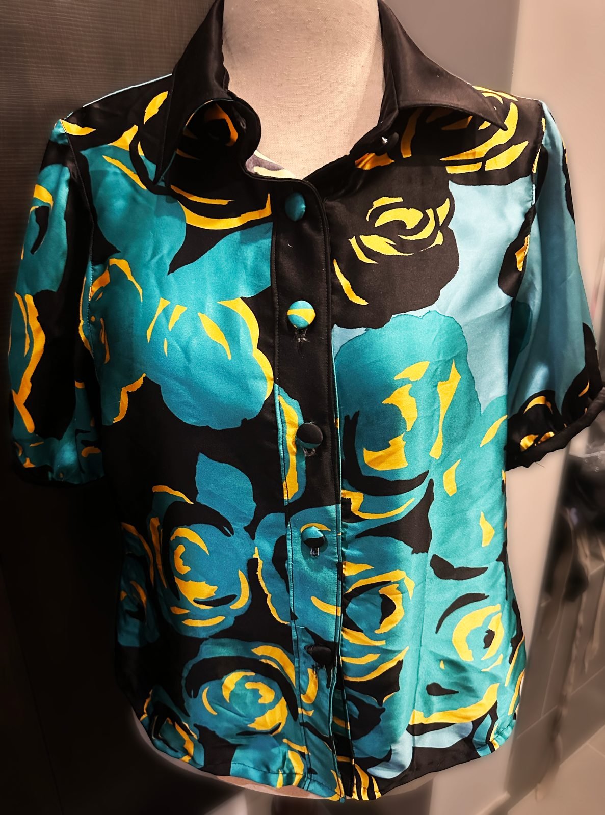 Handmade teal and gold rose print silk shirt on a dress form