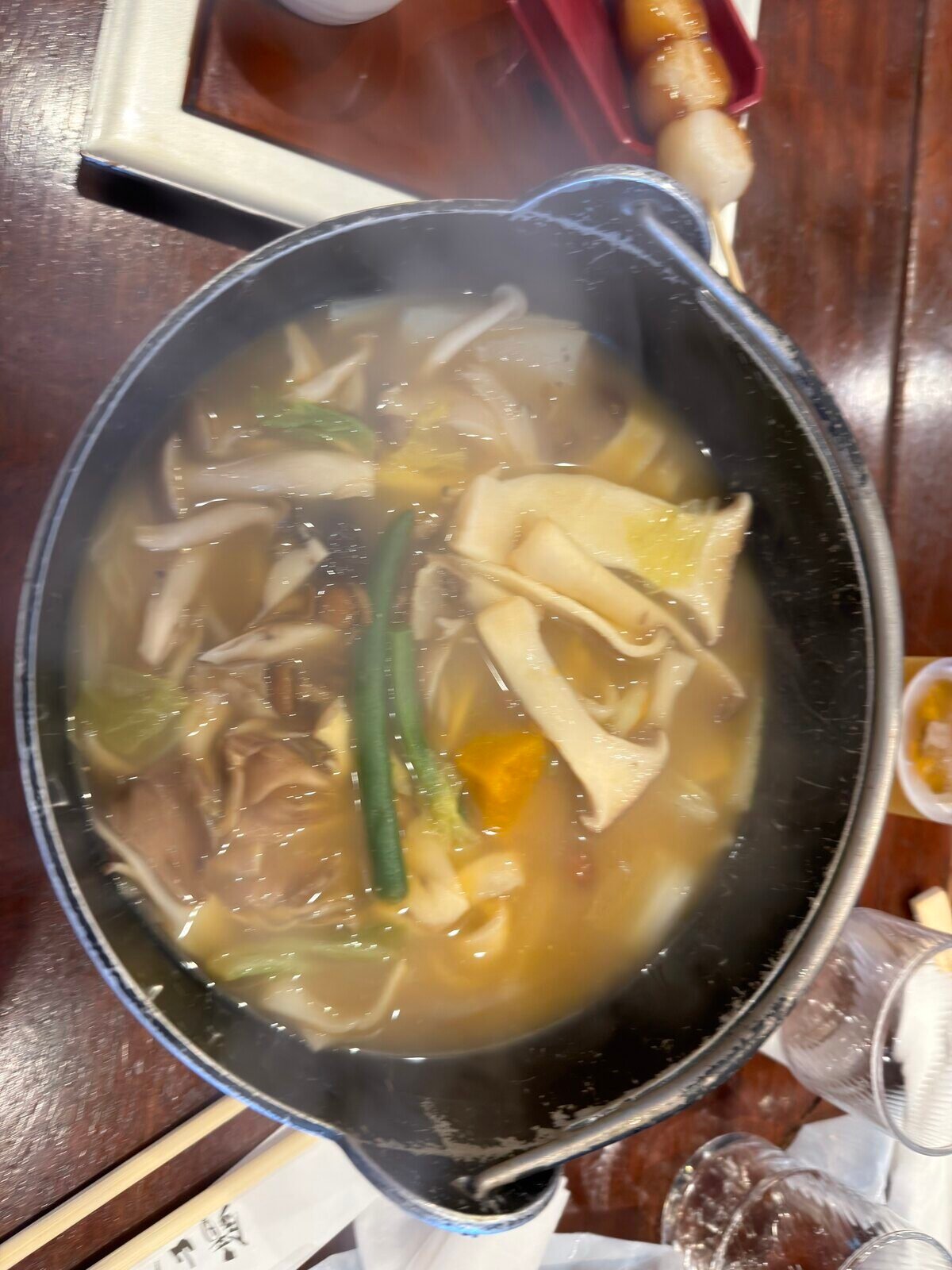 Hoto flat noodles simmering with vegetables in a cast-iron pot