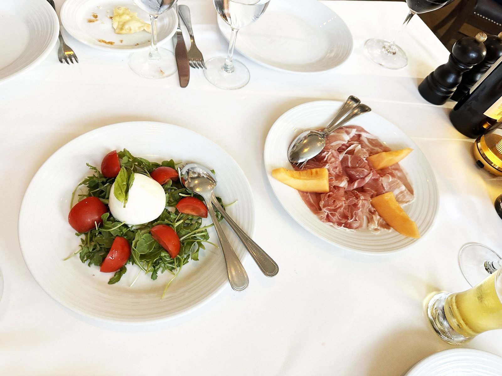 West Hollywood Madeo Ristorante burrata alla caprese with tomatoes and arugula beside prosciutto e melone
