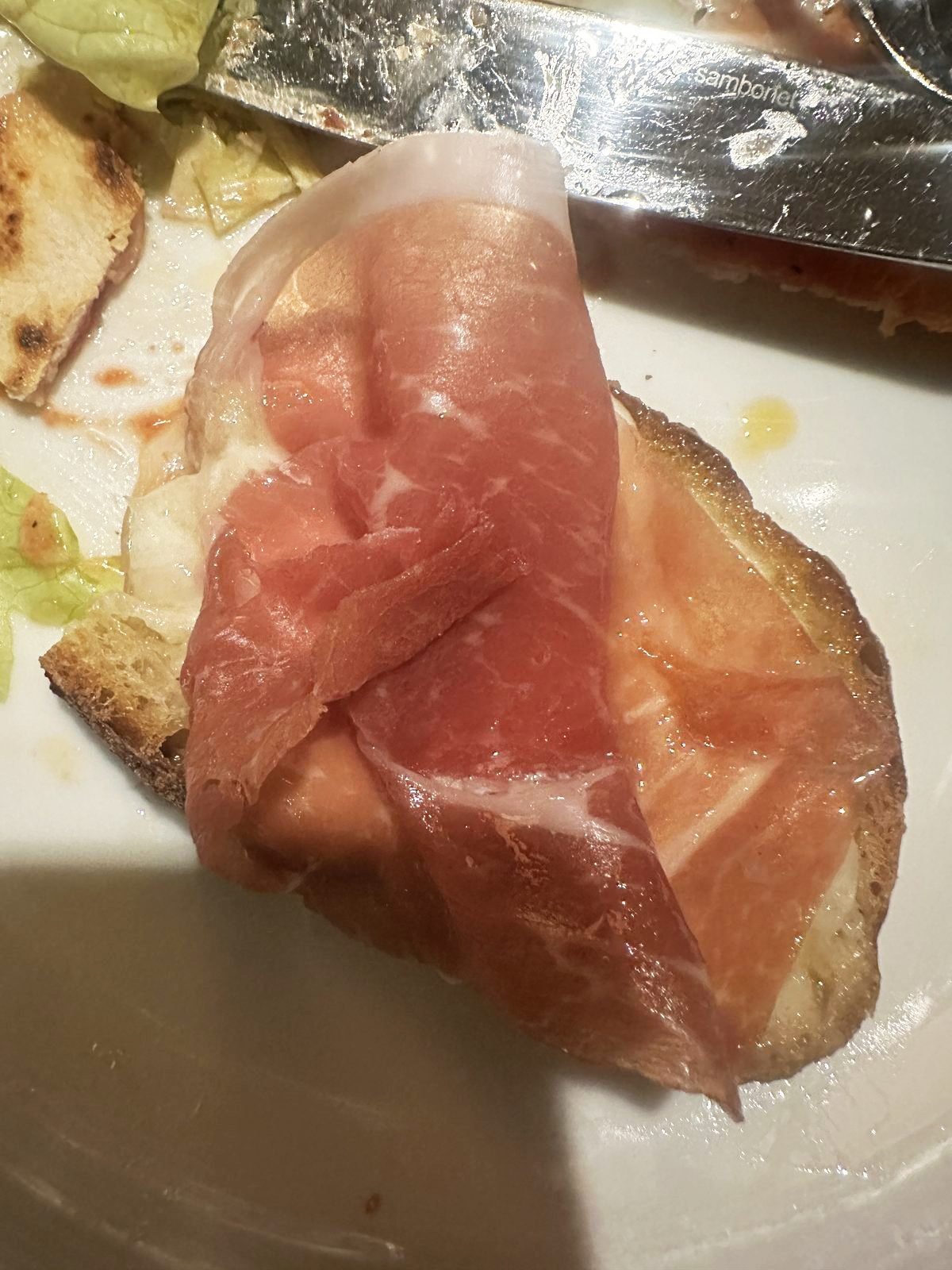 West Hollywood Madeo Ristorante crostino al prosciutto with prosciutto draped over warm bread